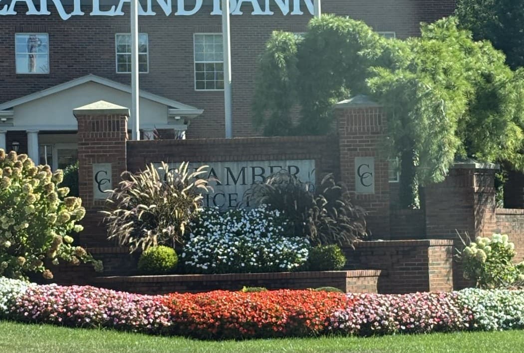 Chamber Center entrance monument in front of the brick Heartland Bank building.